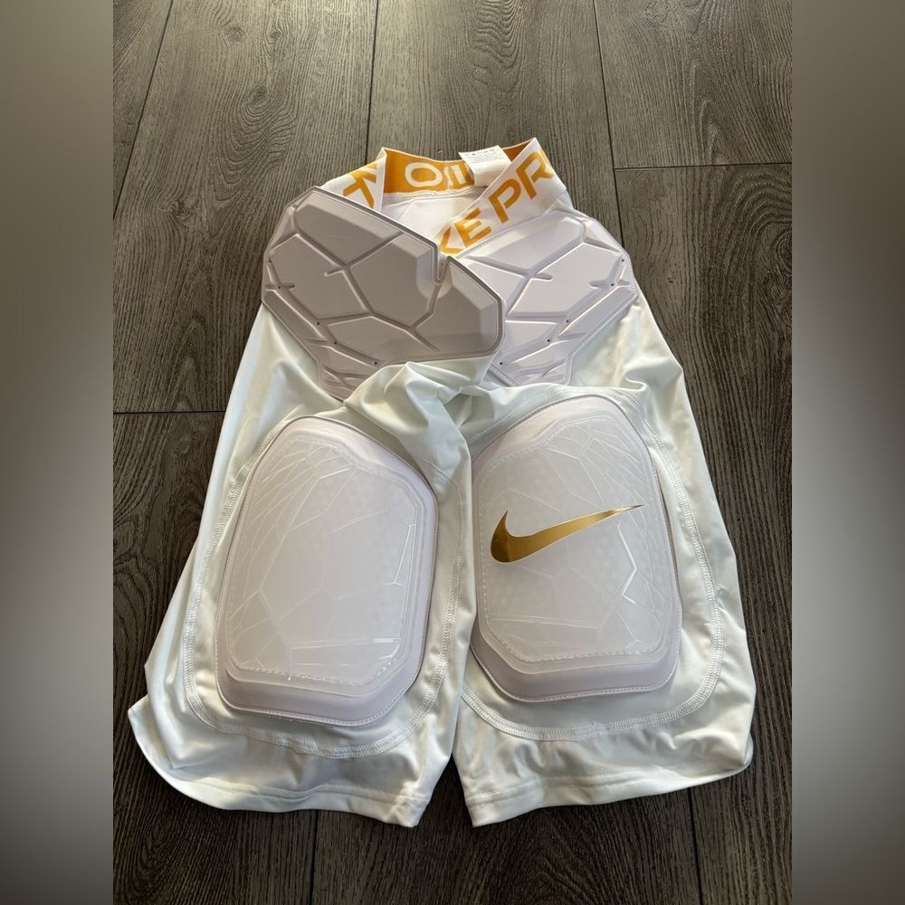 Nike Men’s White Padded Compression Shorts with Gold Swoosh